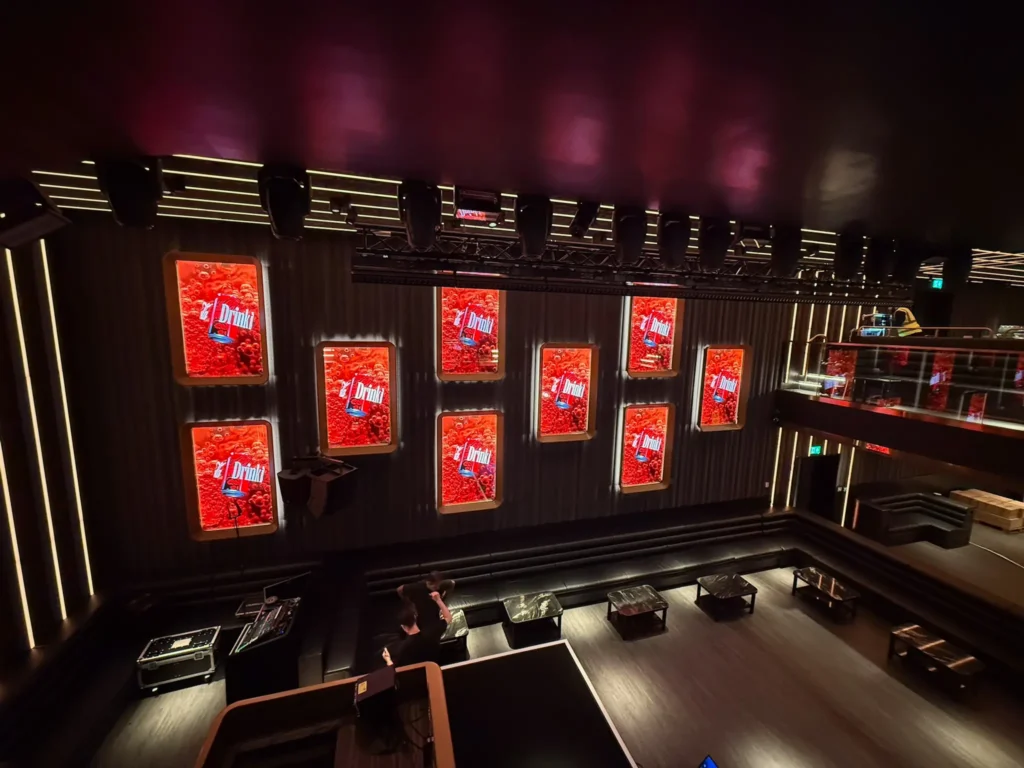 Corporate AV multi-screen wall installation with LED displays and event lighting in a London venue.