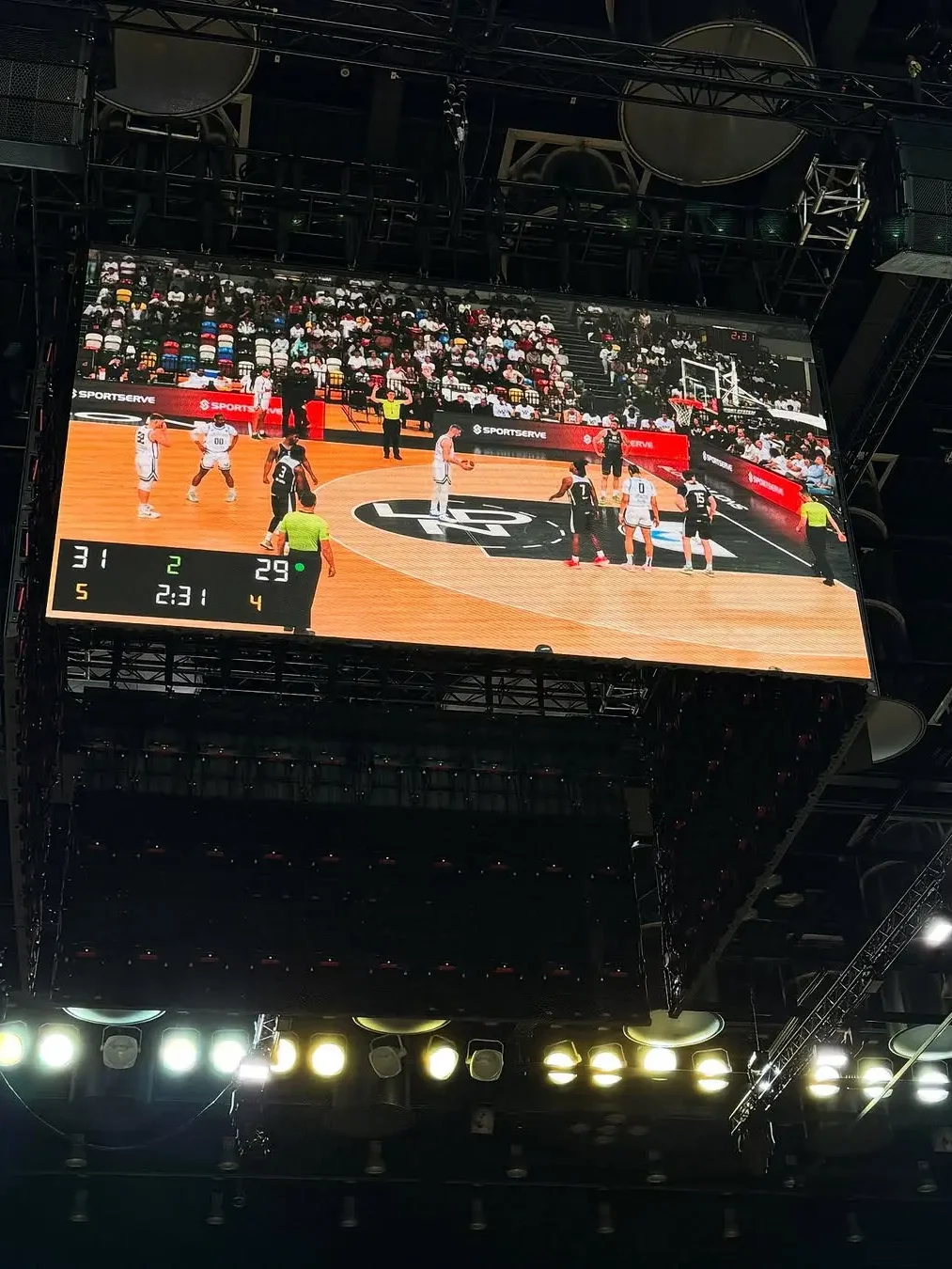 Large suspended LED video screen showing live basketball game footage at Copper Box Arena London