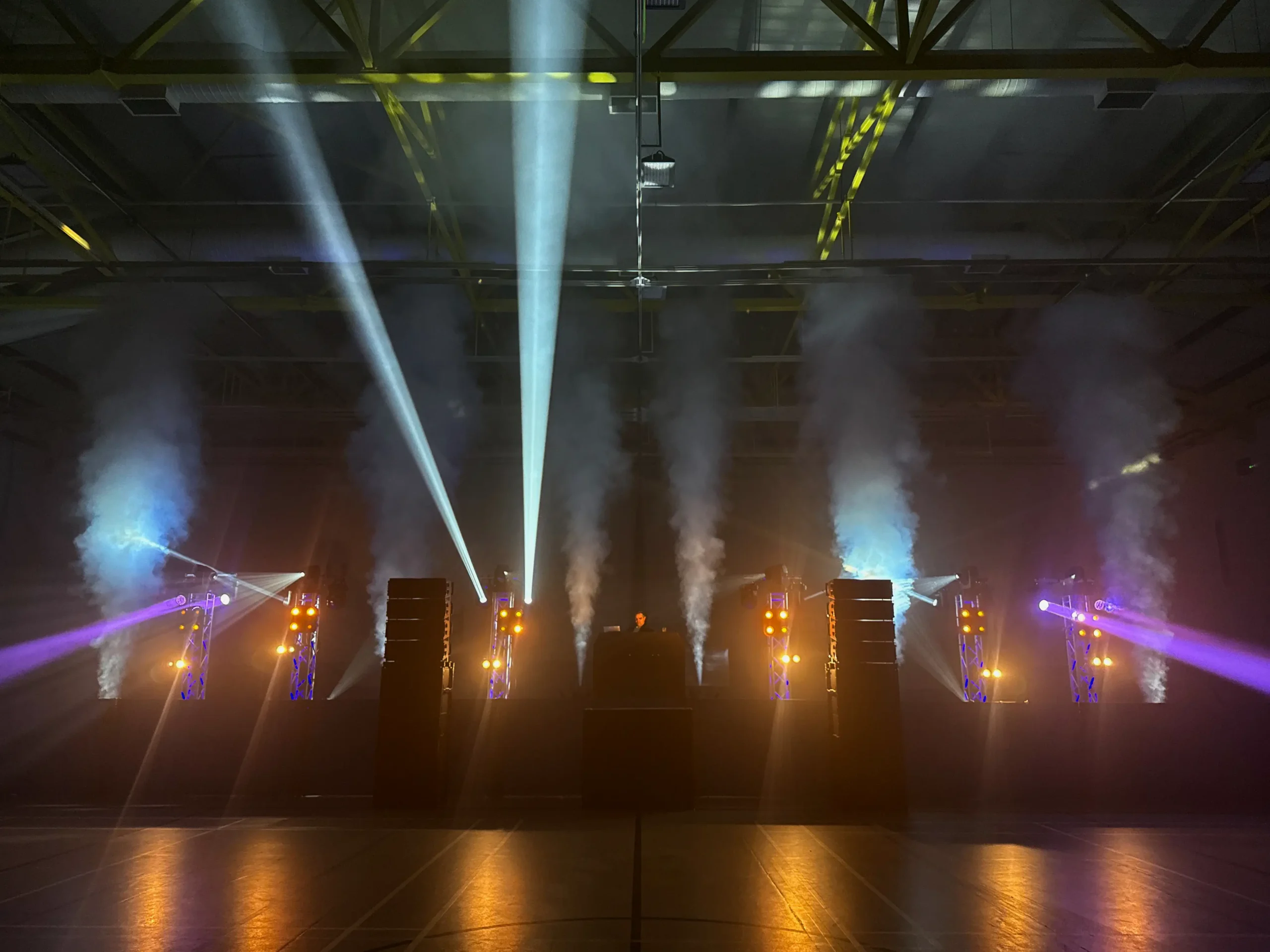 Large-scale corporate event DJ stage with professional lighting and special effects at Christmas party, London