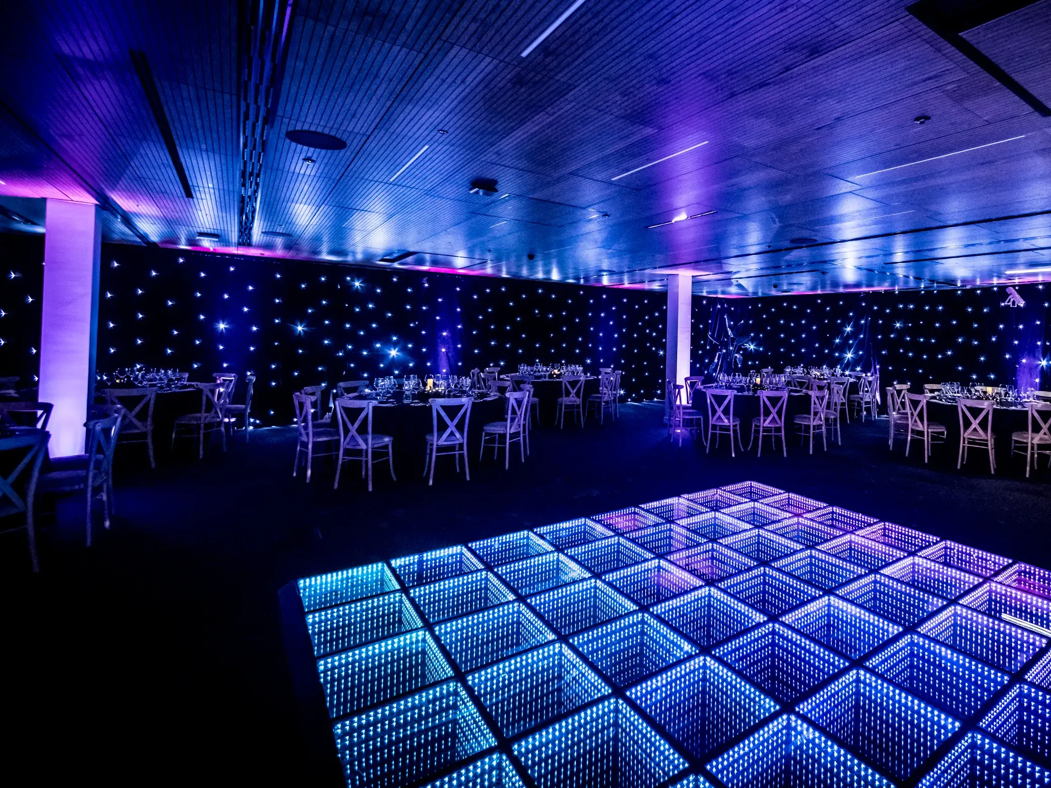 Corporate office event transformation with LED dancefloor, starlight backdrop and professional lighting in London