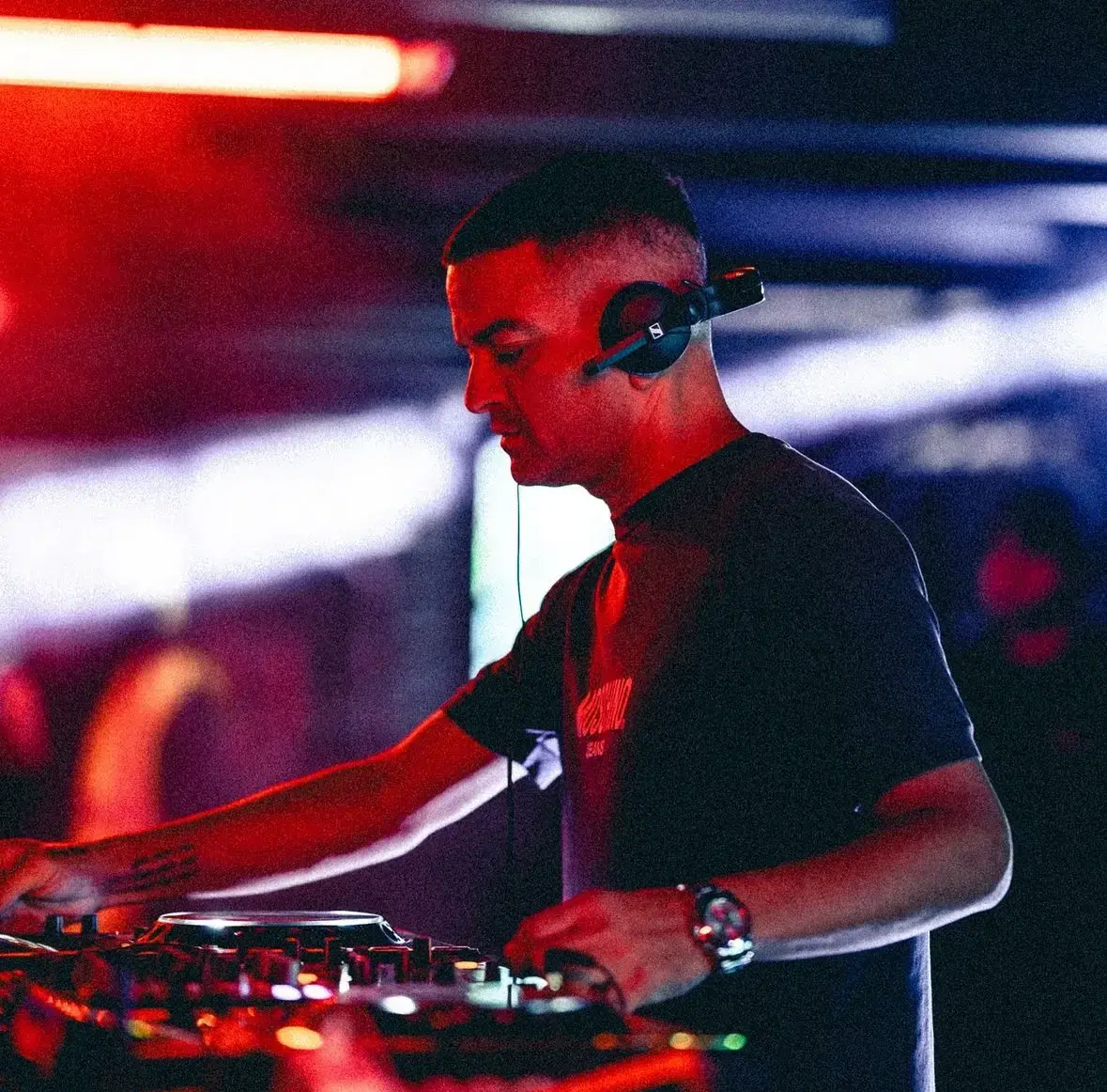 Professional DJ performing live at event with CDJ decks and mixer