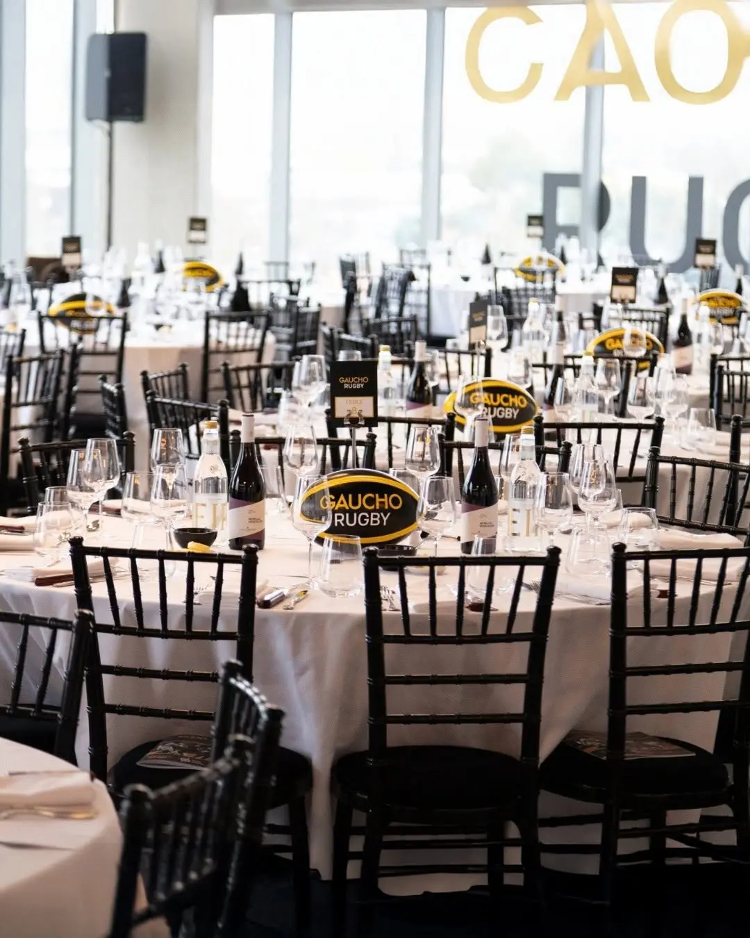 Gaucho Rugby hospitality dining setup with branded tables, event production and corporate hospitality AV environment