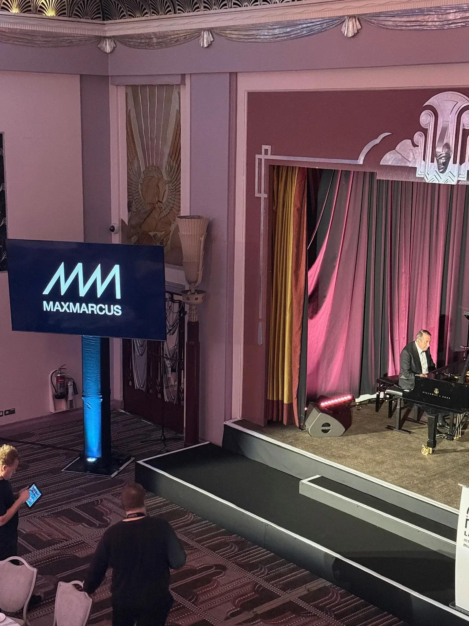 Jools Holland grand piano performance at Lang Lang Foundation gala dinner with branded AV screen and stage lighting, London