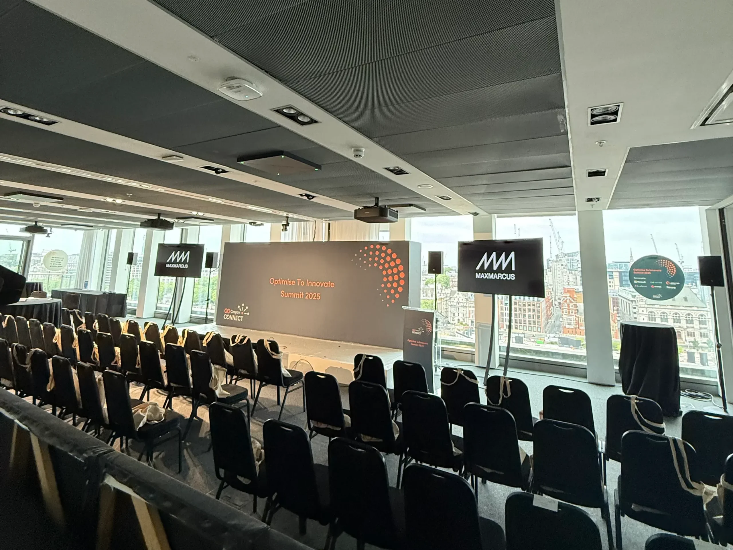 Corporate conference stage setup with LED screens, podium and presentation display