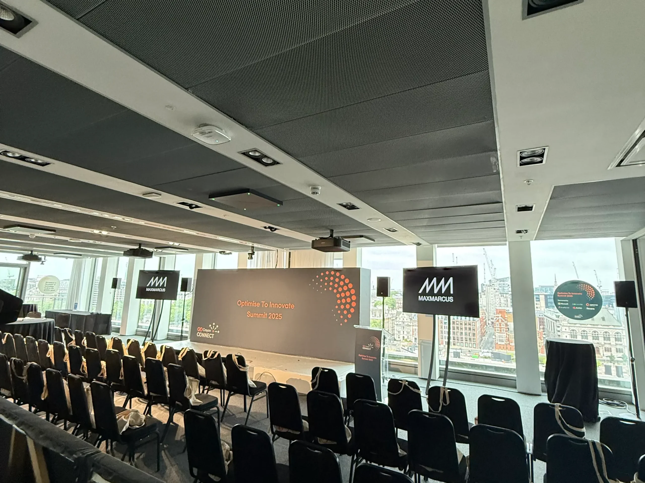 Corporate conference stage setup with LED screens, podium and presentation display