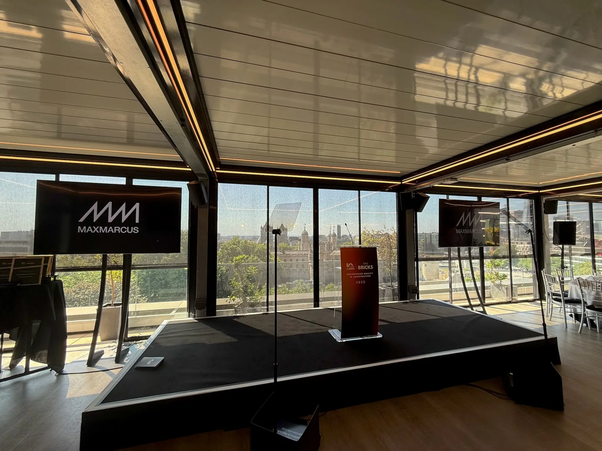 Corporate event production setup with stage, screens and professional AV installation in London venue