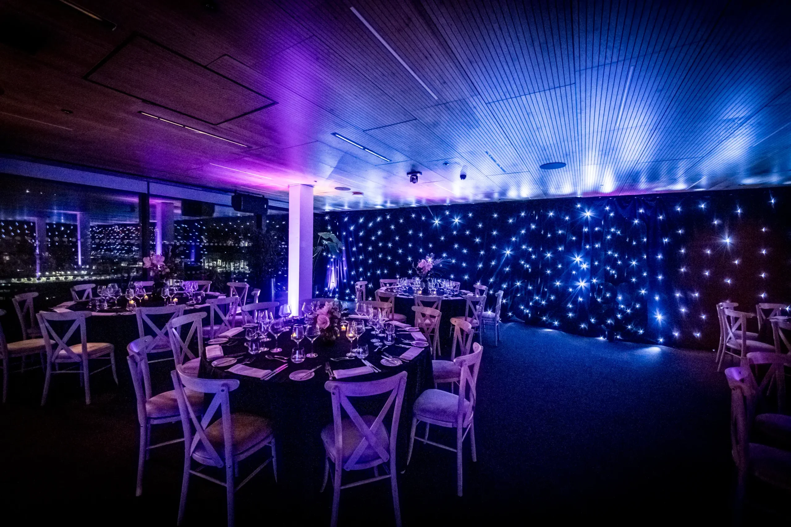 Starcloth draping hire in London transforming a corporate event space with LED backdrop and ambient lighting
