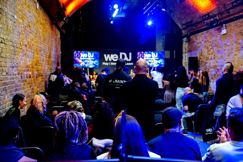 Audience watching a live panel talk in an industrial venue