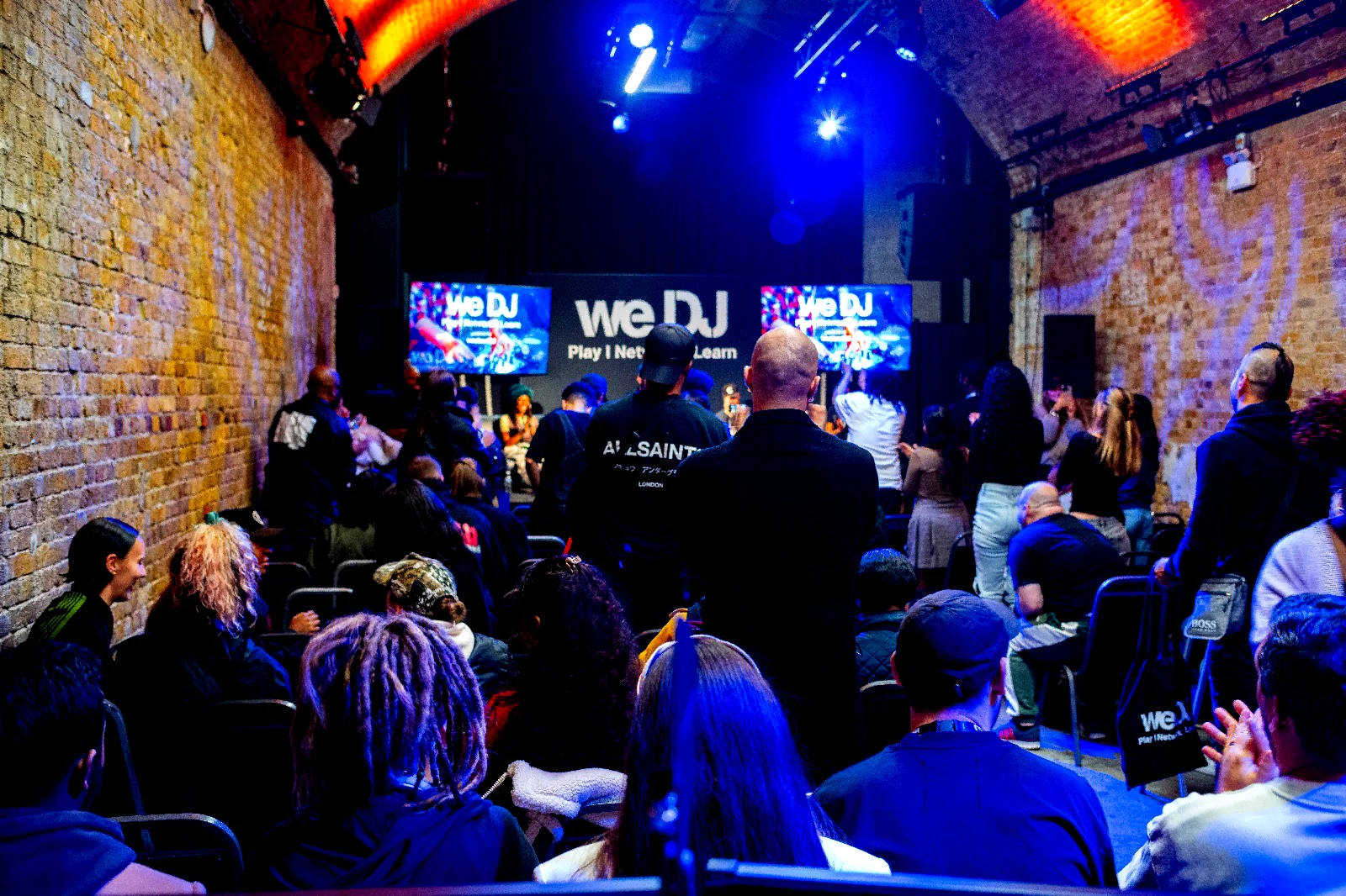 Audience watching a live panel talk in an industrial venue
