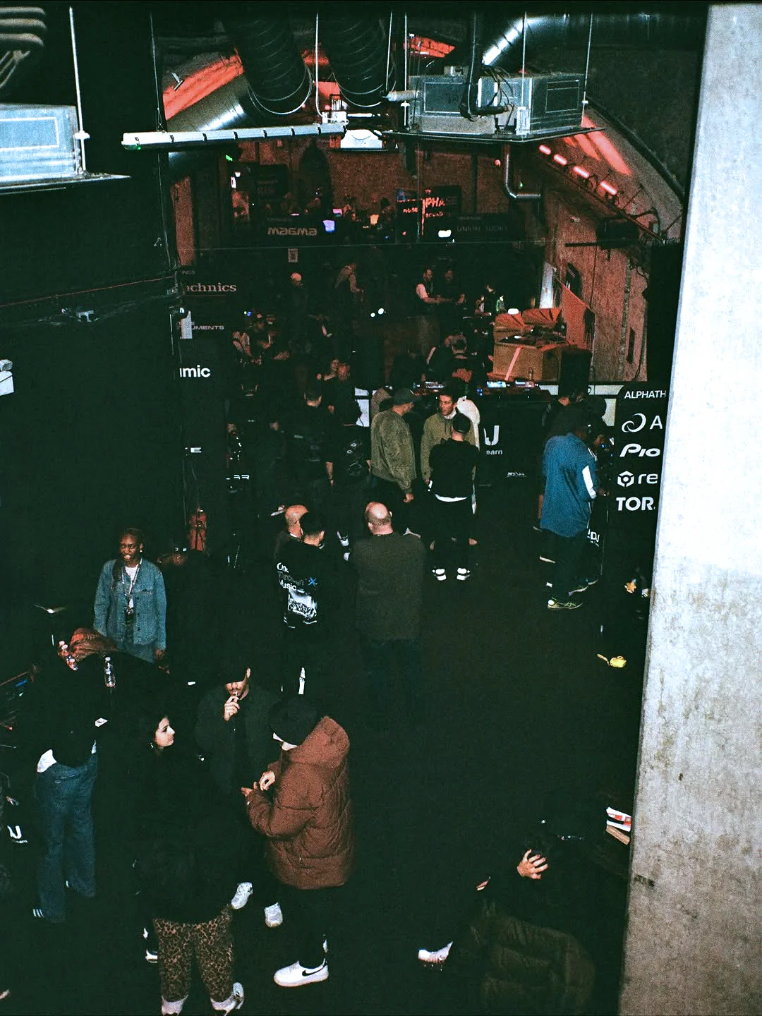 Overhead venue view showing attendees networking and moving through the event space