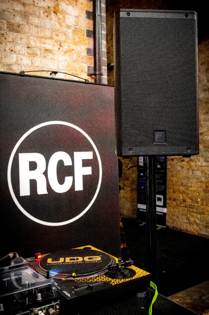 Audience gathered around a live DJ demonstration and technical showcase