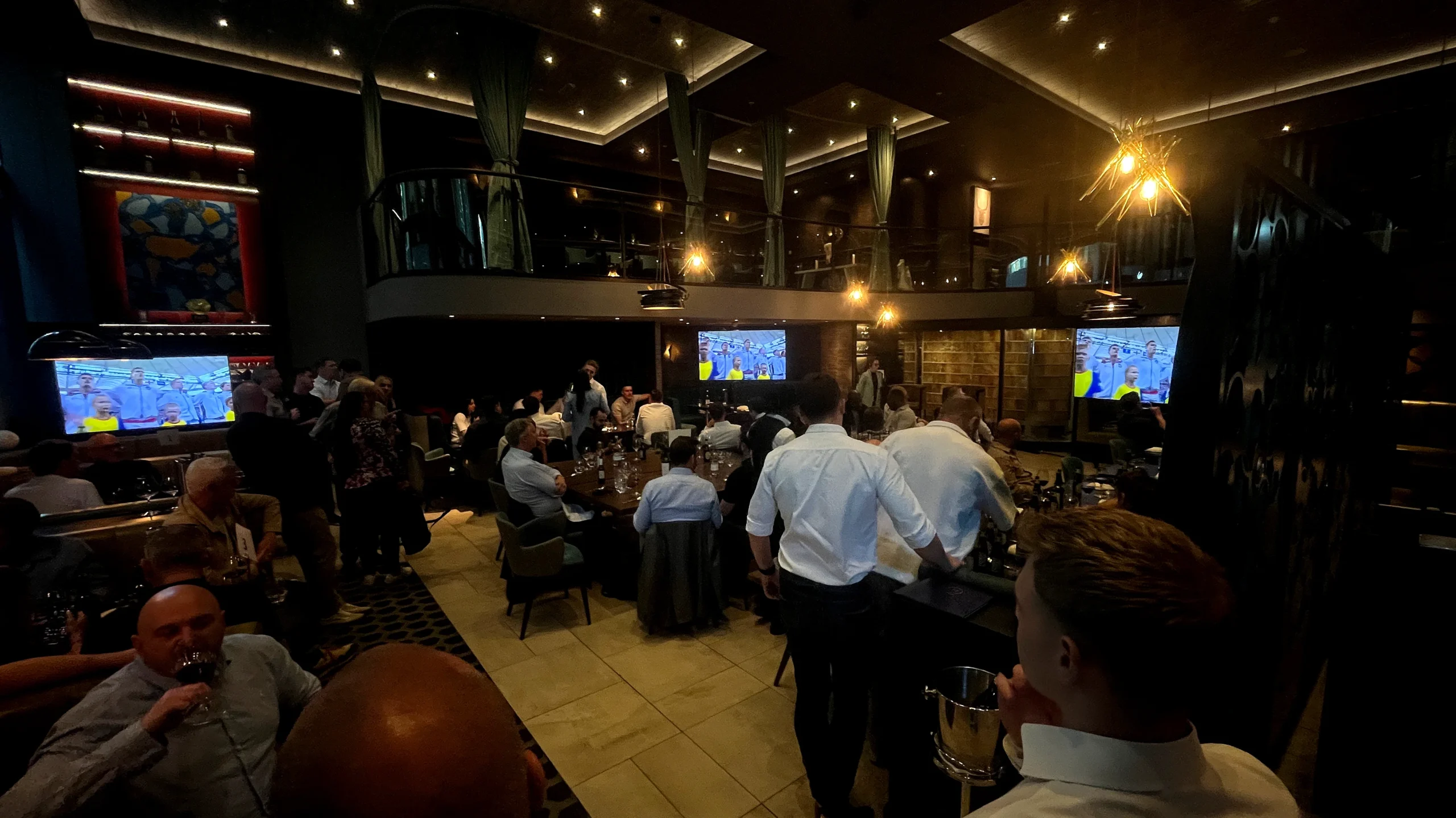 TV screen hire London showing live sports across multiple screens in busy event venue