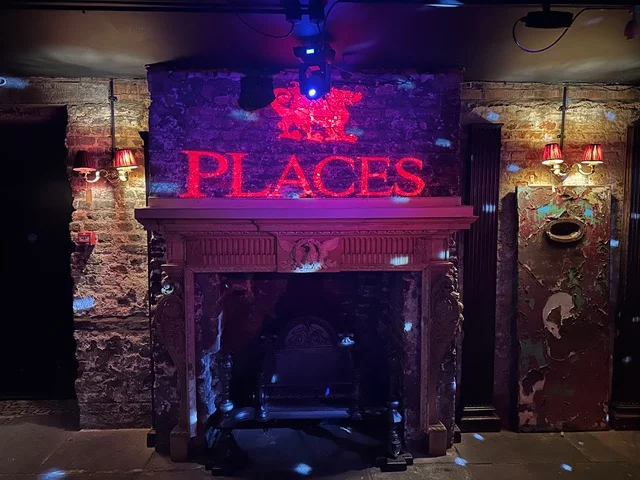 Custom logo projection illuminating a venue feature wall for an event