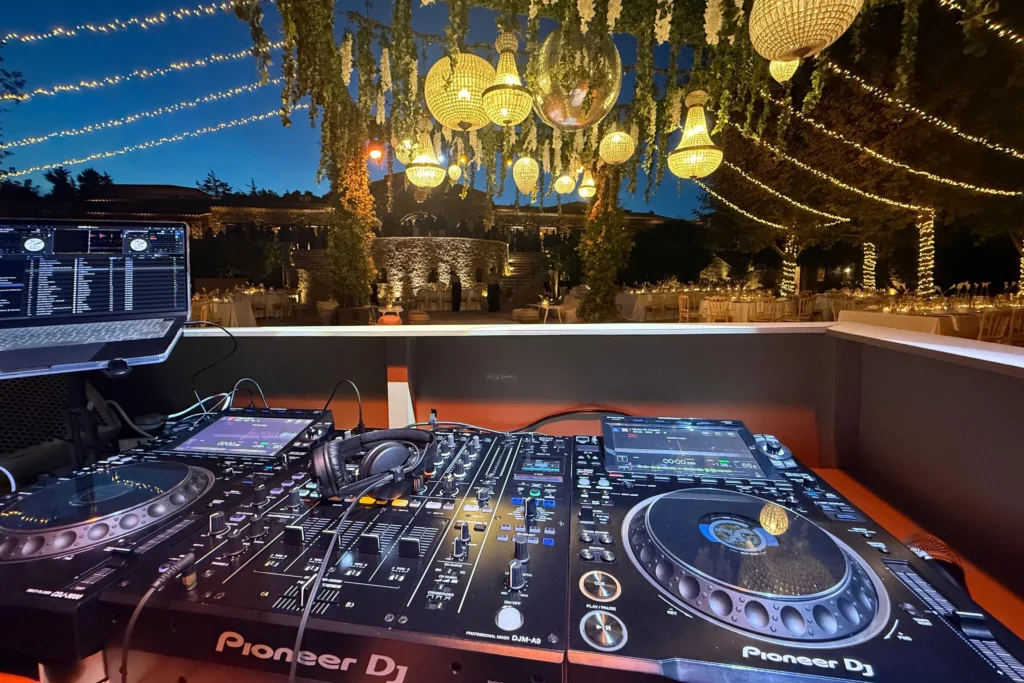 Professional DJ setup overlooking an outdoor destination wedding reception in Greece