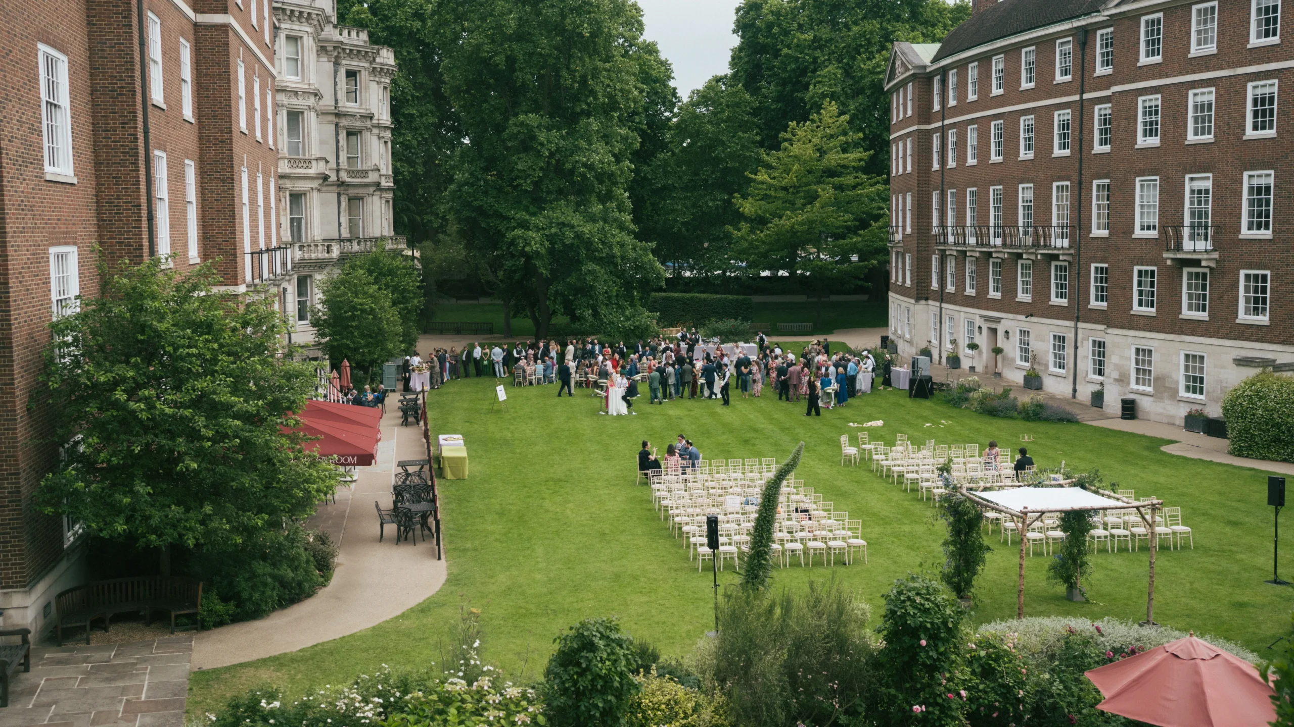 Outdoor wedding ceremony setup with guest seating and sound equipment